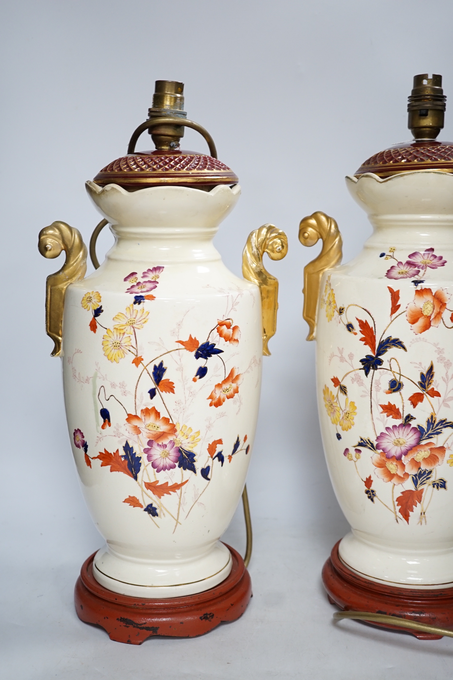 A pair of early 20th century vases mounted as table lamps, hand painted with flowers, 45cm high